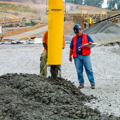 Worker placing concrete with a SlikTremie.